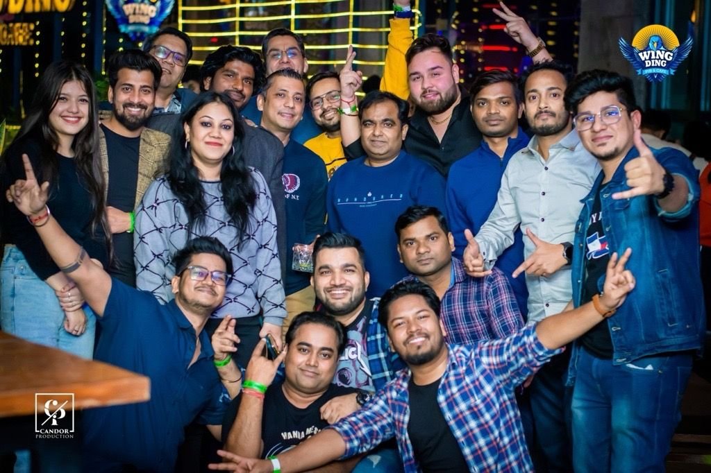 Friends and colleagues cheering together at an evening event.